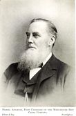 Man with short receding hair and beard, dressed in Victorian clothing