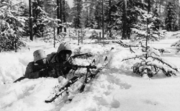 Two men with snowsuits aim a light machine gun at the front.