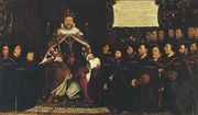 King HenryVIII in full royal regalia surrounded by a kneeling group of men who are all wearing black clothing and some with matching close-fitting caps