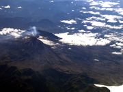 Airphoto of a mountain and white clouds from it