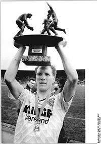 Sammer holds the East German Cup aloft in 1990.