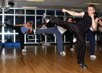 US Navy 040329-N-9296W-004 Lt. Dave Merrifield and other students enjoy a kickboxing workout from instructor Laura Galloway in the Fit Zone Gym aboard Naval Support Activity Naples, Italy.jpg