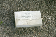 Stone set on the ground which is inscribed with "Justus, first Bishop of Rochester 604-624, fourth Archbishop of Canterbury 624-627, d. 627"