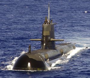 A large submarine travelling on the surface of the ocean.