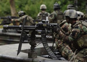 US Navy 070825-N-9769P-317 A Special Warfare Combatant-craft crewman (SWCC) mans his GAU-17 minigun during live-fire patrol training along the Salt River in northern Kentucky.jpg